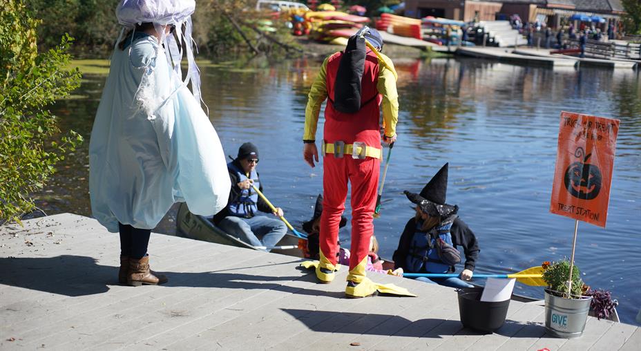 Costumed GIVE 365 volunteers pass out candy at Trick or Treat on the River!