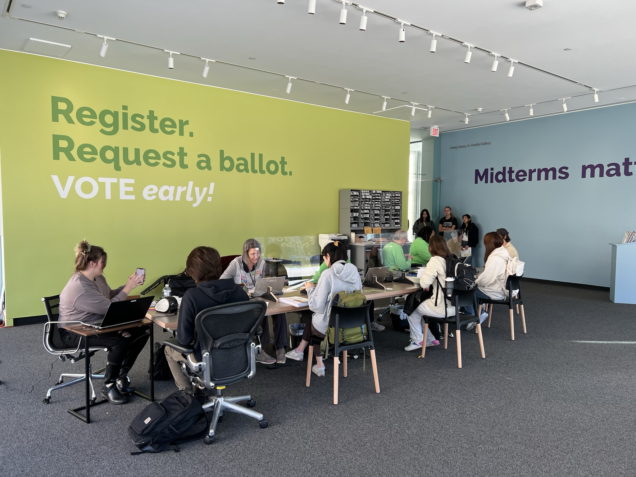 Image of voters registering to vote and picking up their ballots at the University of Michigan Museum of Art