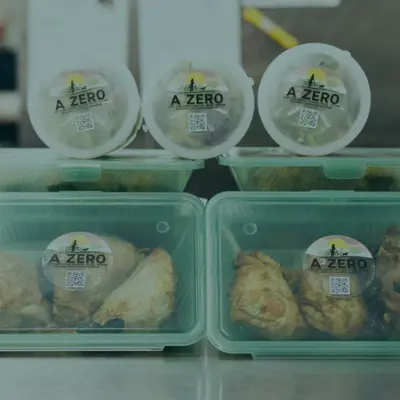 Six plastic, reusable containers labeled with the A2ZERO Logo as part of the A2R3 returnable container program.