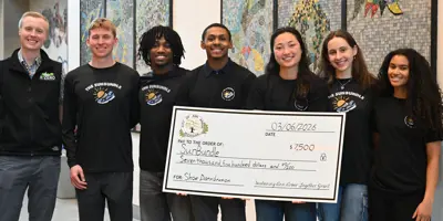 Office of Sustainability and Innovations staff with SunBundle, holding a big check made out to SunBundle.