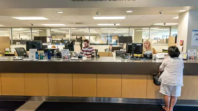 People at the customer service desk in Larcom City Hall